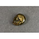 A novelty brass vesta case fashioned as a human skull, the jaw opening to reveal void for storage,
