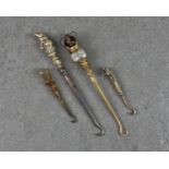 A small group of four novelty Victorian and later button hooks, comprising of a Mr Punch version,