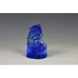 A Chinese limited edition blue glass lion, seated biting paw, raised on naturalistic base, dated,