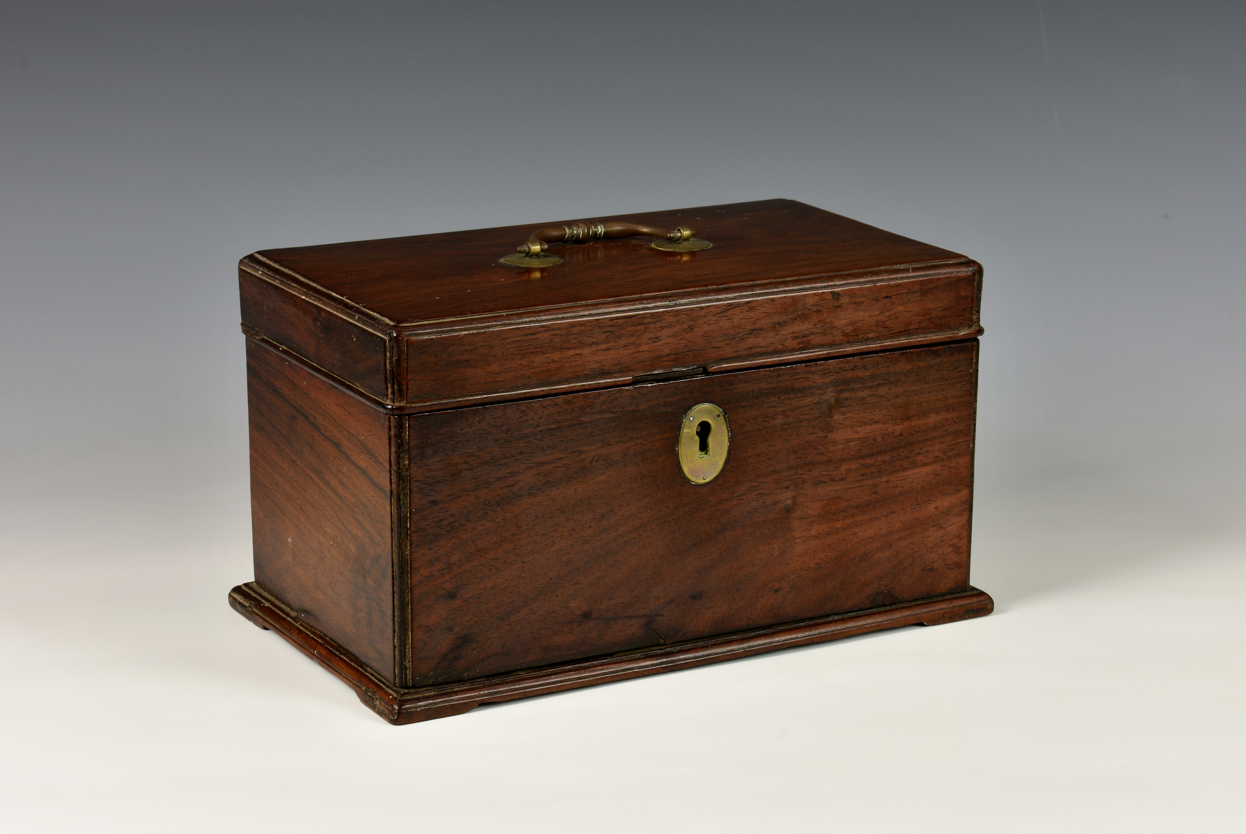 A George III Anglo-Chinese padouk wood tea caddy, of sarcophagus form, the hinged lid with ornate