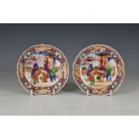 A pair of Chinese porcelain mandarin palette saucers, 18th century, deeply dished with barbed rim,