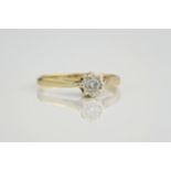 A 9ct yellow gold and diamond solitaire ring, the diamond in an illusion setting. Ring size M.