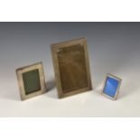 Three silver mounted easel back photo frames, the largest Birmingham, 1921, maker's mark indistinct,
