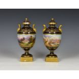 A fine pair of Coalport porcelain urn shaped vases with covers, early 20th century, of typical
