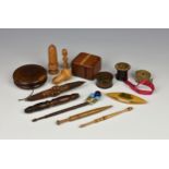 A small collection of antique treen sewing accessories, to include a Mauchline ware thread holder '