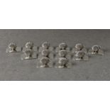 A set of twelve novelty Continental silver place card holders in the form of scallop shells, each