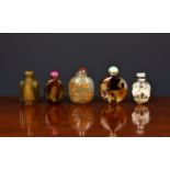 A collection of five Chinese agate snuff bottles, 20th century, to include a version of flattened