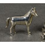 A modern miniature cast silver figure of a horse, stamped sterling 925, standing 1½in. (3.8cm.)