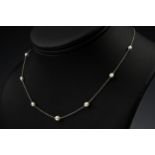 A vintage platinum and pearl necklace, 1930s-50s, the trace chain set with seven small ovoid pearls,