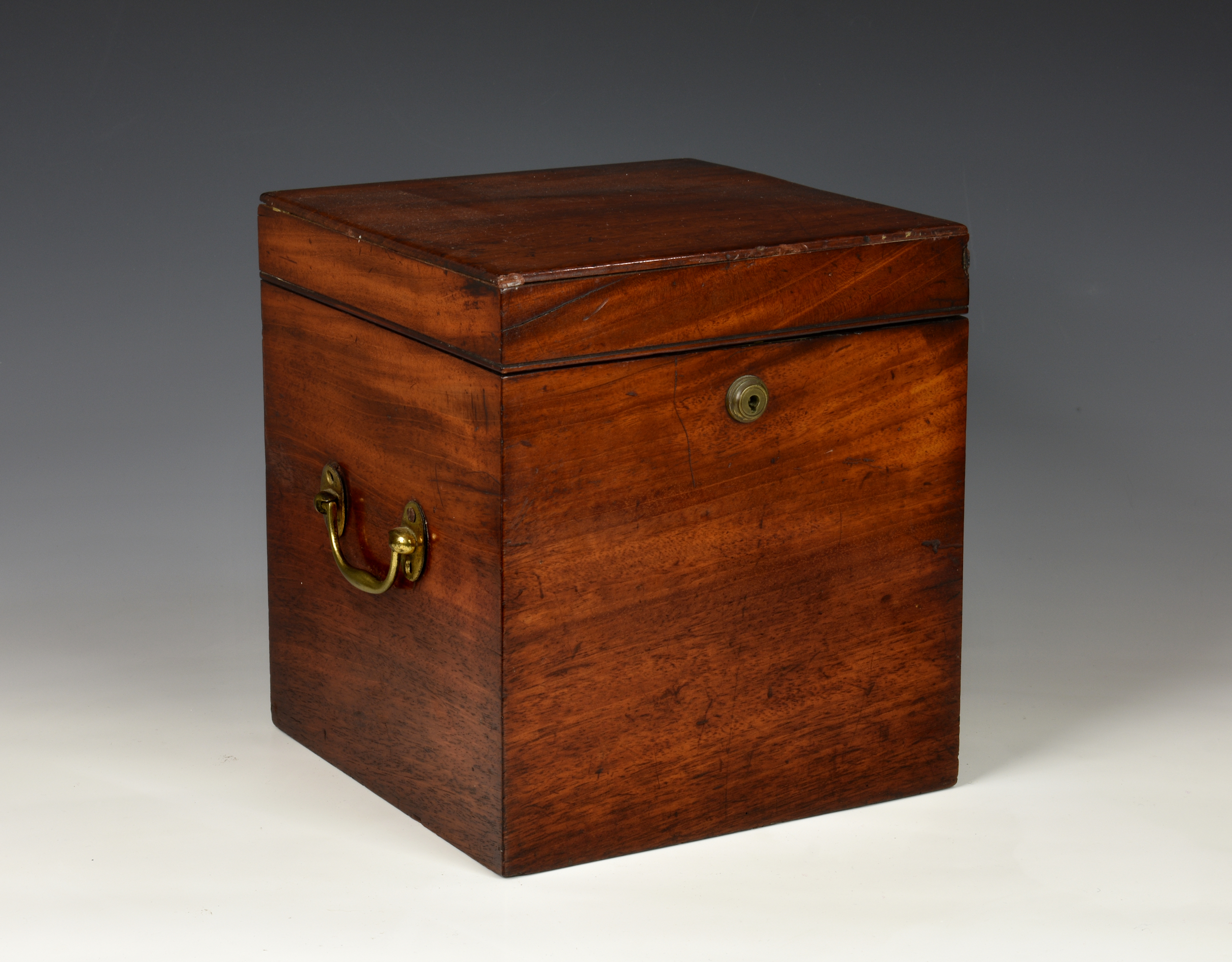 A 19th century four division mahogany decanter box, having brass side carrying handles, the hinged