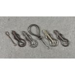 A collection of antique folding French 'Mandoline' steel button hooks, of similar design, each