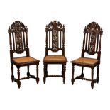 A set of three Victorian carved oak Carolean style side chairs, the backs with central fruiting vine