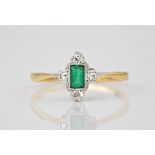 A vintage 18ct gold, emerald and diamond ring, featuring a step cut emerald measuring