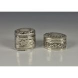 Two white metal trinket boxes, possibly Continental to include shaped oval box with hinged cover and