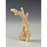 A Chinese carved angel skin coral figure, 20th century, depicting a female deity in flowing robes