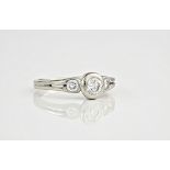 An 18ct white gold and diamond three stone ring, totalling approximately 0.70ct, the central