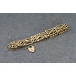A 9ct gold gate link bracelet with heart padlock charm, the bracelet measuring approximately 186mm