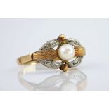 An 18ct two toned gold, pearl and paste ring, the central pearl measuring approximately 5mm in