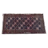 A Turkoman Beshir rug, with geometric all over design decorated with alternating rosettes in madder,