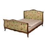 A French Louis XV style double bed, late 20th century, in beech wood, the serpentine foliate and