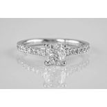 An 18ct white gold and diamond solitaire ring, the central cushion cut diamond weighing