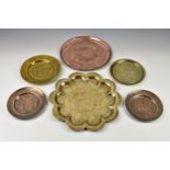 A small collection of Persian Middle Eastern copper and brass platters and plates, of varying