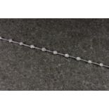 An 18ct white gold and diamond bracelet, intermittently studded with 19 brilliant cut diamonds