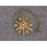 An antique 15ct yellow gold and seed pearl star brooch, measuring approximately 28mm in diameter and