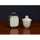 A Chinese pale jade snuff bottle, of flattened vase form with carved twin mask ring handles, with