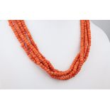 A Victorian coral choker necklace, the four strands of coral beads with rolled gold clasp.