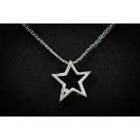 A 9ct white gold and diamond star pendant, set with a single small brilliant cut diamond, on a 9ct