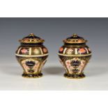 A pair of Royal Crown Derby Imari pattern vases, with covers, of squat baluster form, decorated in