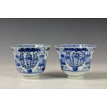 A closely matched pair of Chinese blue and white porcelain tea bowls, both with four character