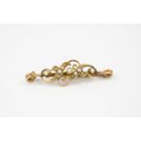 A 14ct yellow gold and seed pearl bar brooch, early 20th century, the scrolled, openwork brooch