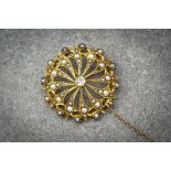 An Edwardian 18ct yellow gold, seed pearl and diamond star pendant brooch, the twelve pointed star