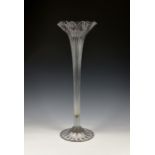 A Victorian clear glass lily vase, with ribbed elongated stem and folded foot, 24in. (61cm.) high.