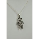 A novelty silver articulated teddy bear pendant, stamped 925, the bear with moving limbs and head,