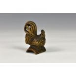 A Japanese carved wooden netsuke fashioned as a cockerel, probably early 20th century, having