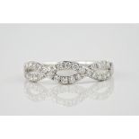 A 9ct white gold and diamond twist ring, set with pavé diamonds totalling approximately 0.30ct. Ring
