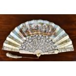 An early 19th century French carved and silver gilt inlaid bone fan, the guards with shell carving
