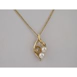 A 9ct gold, pearl and diamond necklace, featuring 2 pearls and 2 diamonds in an asymmetrical design.