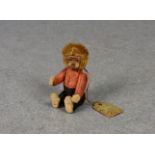 A miniature Schuco bellhop monkey, 1950s, 2 3/8in. (6cm.) tall.