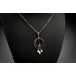An Art Deco style 9ct gold, baroque and seed pearl pendant, 43mm. drop, on a 9ct gold fancy link
