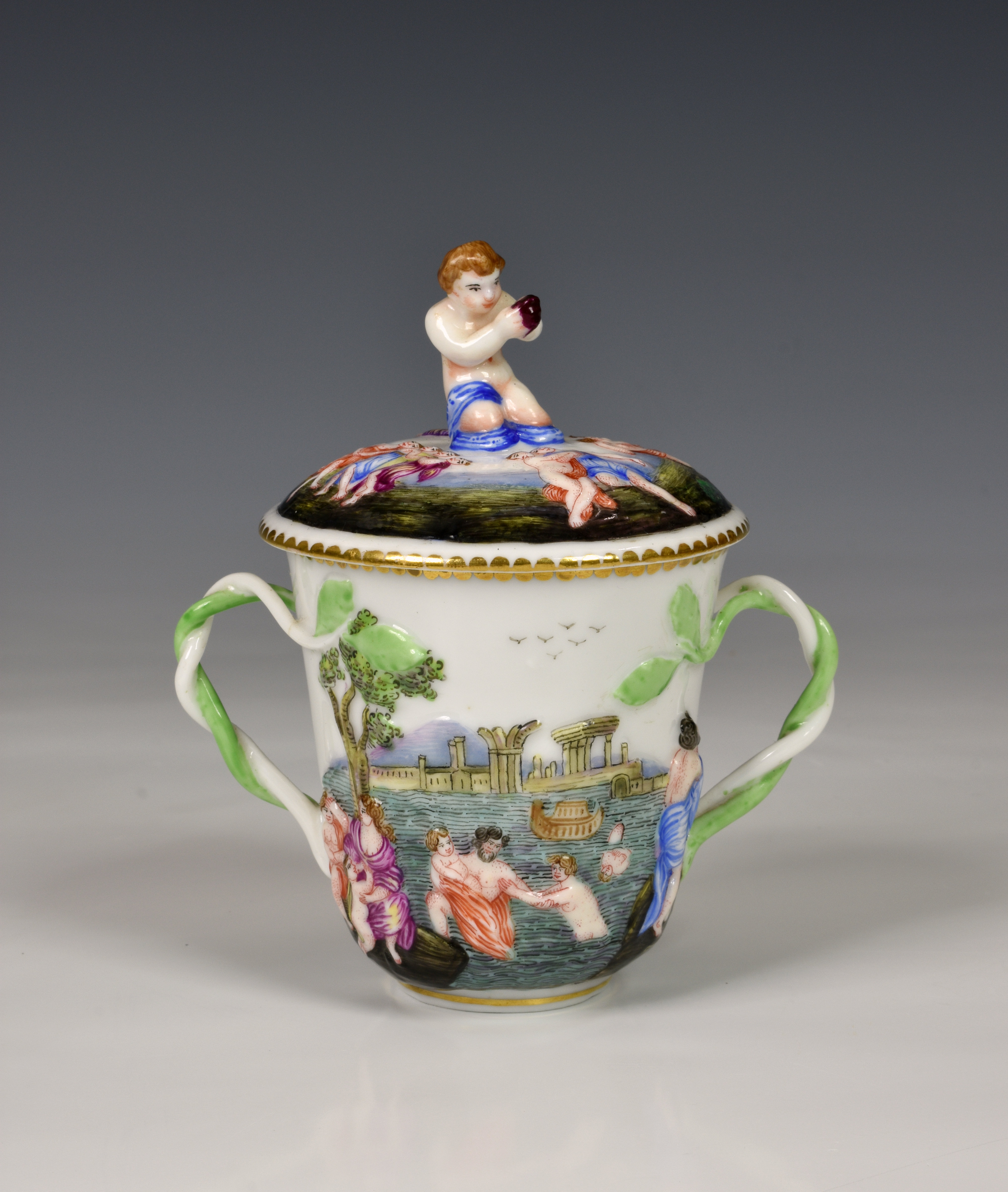 A 19th century Capodimonte chocolate cup and cover, of typical form decorated with figures bathing