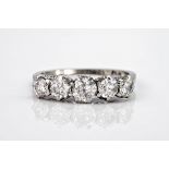 An 18ct white gold and platinum 5 stone diamond ring, the graduating brilliant cut stones
