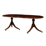 A Regency style cross banded mahogany double pedestal dining table, mid-20th century, with one