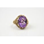 A modernist style 9ct gold and amethyst ring, hallmarked London 1971, the oval cut 15.5 x 12mm.