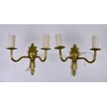 Twelve twin branch brass wall lights, with ornate fleur de lys cast backplates, ribbed branches