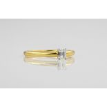 An 18ct yellow gold and diamond single stone ring, the emerald cut diamond totalling approximately