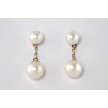 A pair of 9ct yellow gold and pearl drop earrings, with post backs for pierced ears.